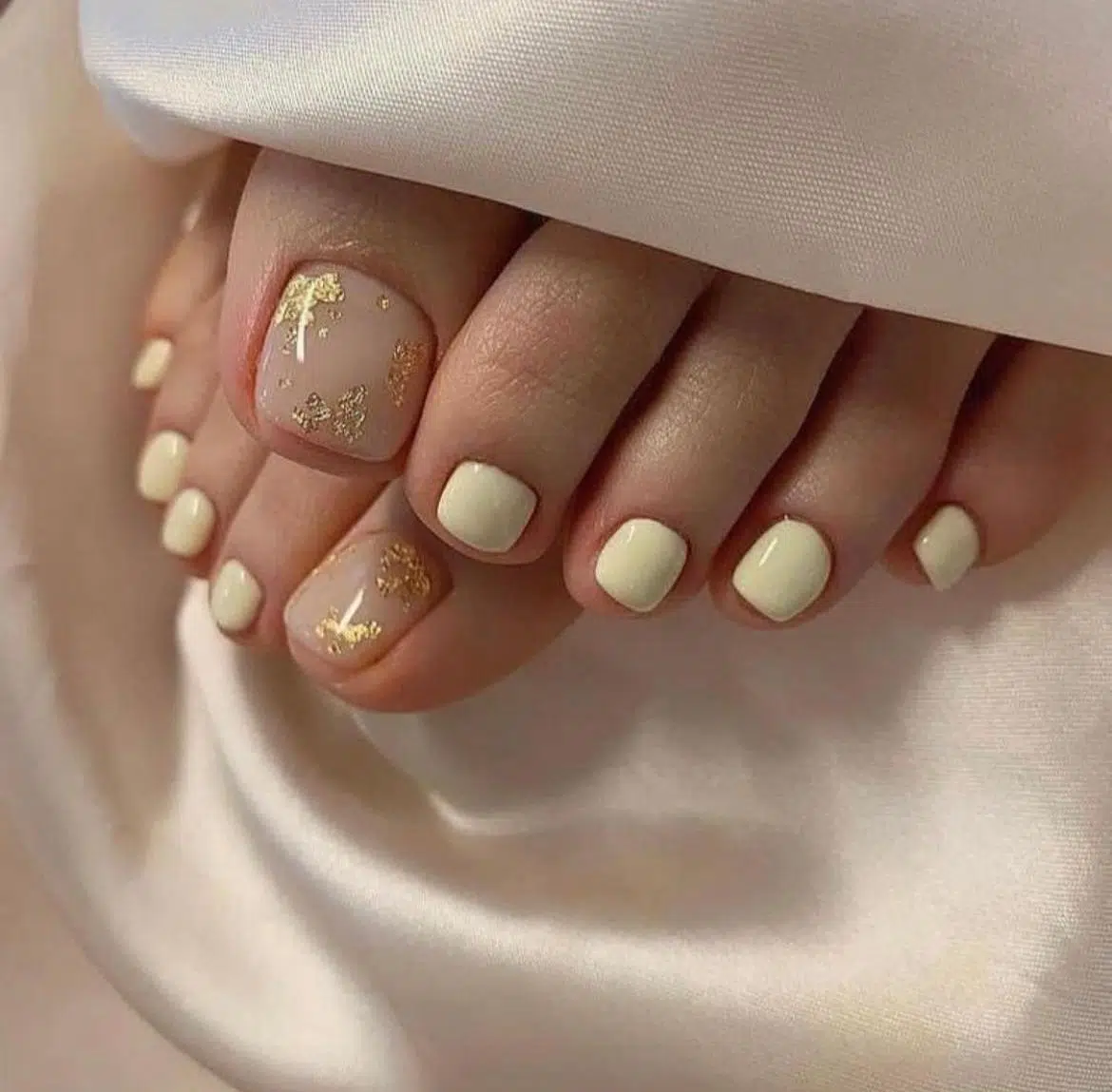 Classic pedicure with foot soak and pale pink polish on toenails
