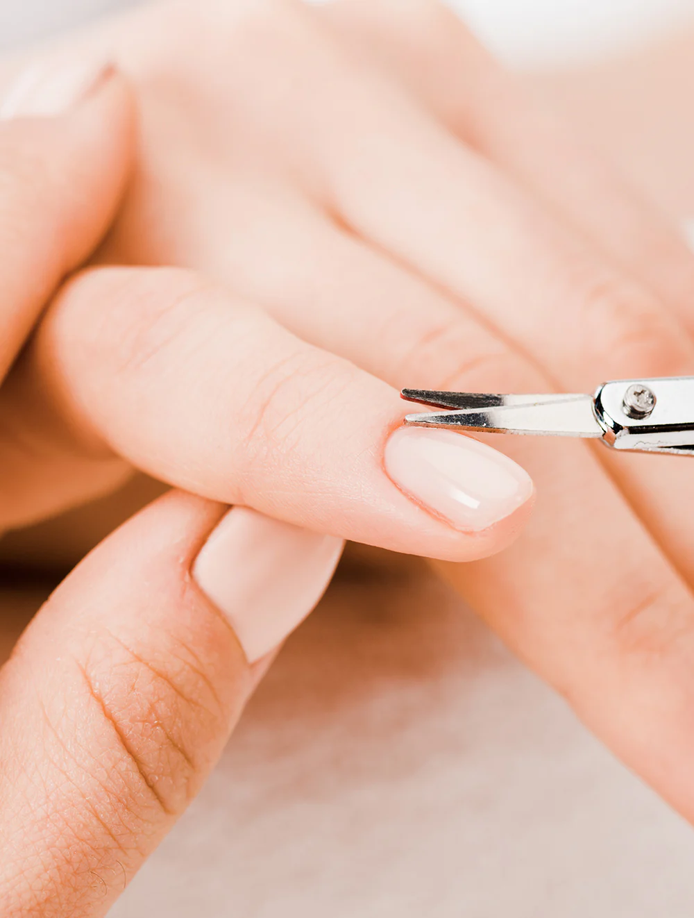 Classic manicure with natural pink polish on shaped nails