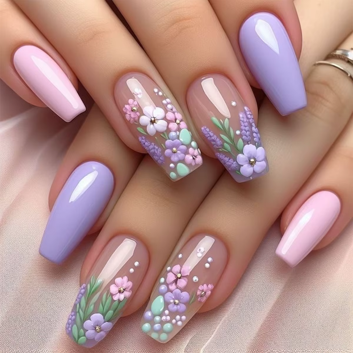 Detailed nail art design with floral motifs on short nails